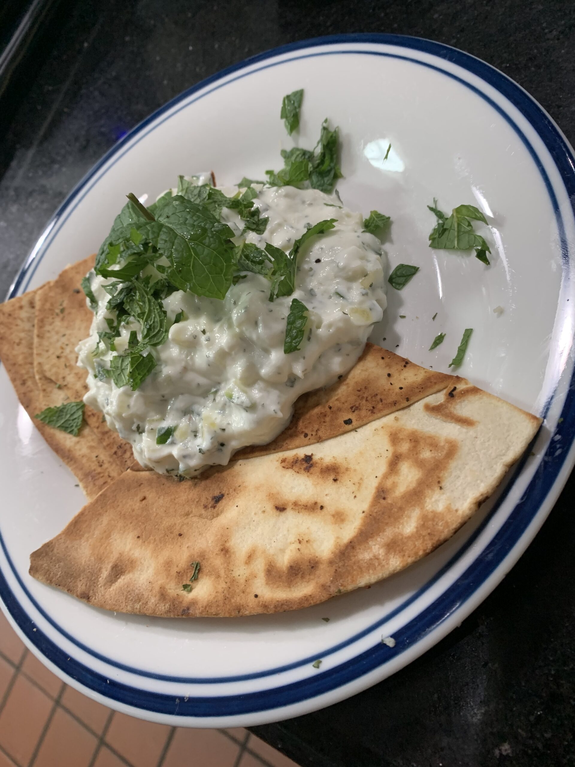 Cucumber Salad - Chopped cucumber tossed with yogurt, dry mint, and pita bread.